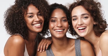 Portrait of young multiracial women standing together and smiling