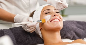 female patient having product applied to face by a specialist