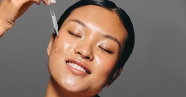 woman applying dermaquest serum to her face