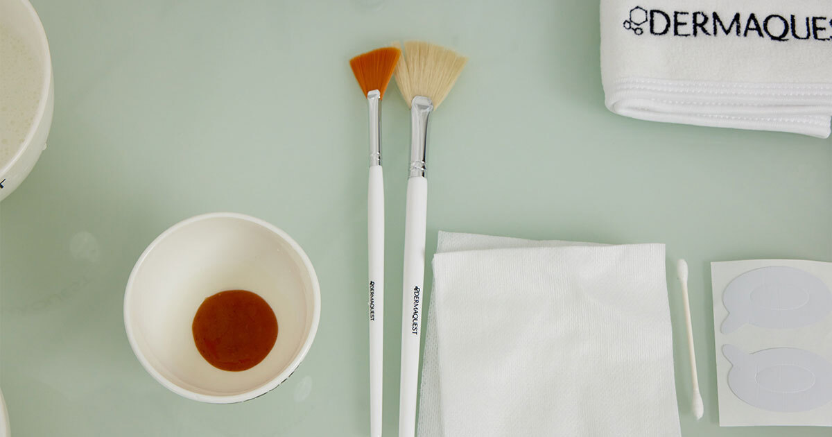 dermaquest primary pumpkin product in a bowl along with brushes and towels